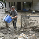 
              Members of the local Mennonite community remove mud filled debris from homes following flooding at Ogden Hollar in Hindman, Ky., Saturday, July 30, 2022. (AP Photo/Timothy D. Easley)
            