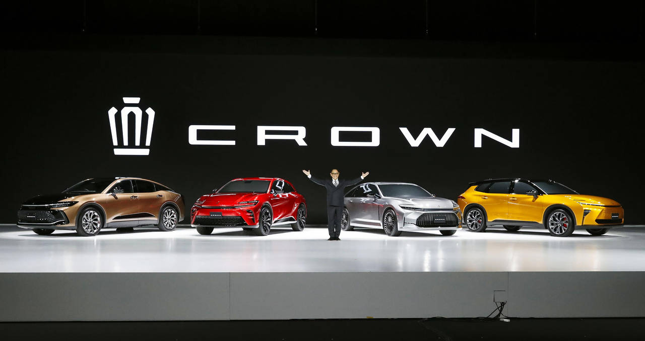 Toyota Chief Executive Akio Toyoda poses in front of its new Crown family of vehicles in Chiba, nea...