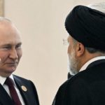 
              FILE - Russian President Vladimir Putin, left, speaks to Iran's President Ebrahim Raisi, back to a camera, on the sideline of the summit of Caspian Sea littoral states in Ashgabat, Turkmenistan, on June 29, 2022. Putin's visit to Iran starting Tuesday, July 19, is intended to deepen ties with regional heavyweights as part of Moscow's challenge to the United States and Europe amid its grinding campaign in Ukraine. (Grigory Sysoyev, Sputnik, Kremlin Pool Photo via AP, File)
            