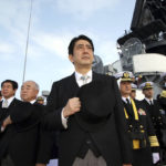 
              FILE - Then Japanese Prime Minister Shinzo Abe, center, and Director of Japan Self-Defense Force Fumio Kyuma, 5th left, salute while assisting at the Fleet Review of the Japan Maritime Self-Defense Force in Sagami Bay, off south Tokyo, Sunday, Oct. 29 2006. Former Japanese Prime Minister Abe, a divisive arch-conservative and one of his nation's most powerful and influential figures, has died after being shot during a campaign speech Friday, July 8, 2022, in western Japan, hospital officials said.(AP Photo/Franck Robichon, File)
            