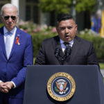 
              President Joe Biden listens as Uvalde, Texas pediatrician Roy Guerrero speaks during an event to celebrate the passage of the "Bipartisan Safer Communities Act," a law meant to reduce gun violence, on the South Lawn of the White House, Monday, July 11, 2022, in Washington. (AP Photo/Evan Vucci)
            