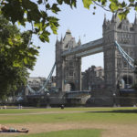 
              A man shields his eyes from the sun as he sunbathes backdropped by Tower Bridge in London, Tuesday July 19, 2022. Millions of people in Britain woke from the country's warmest-ever night and braced for a day when temperatures could break records. Britain is the latest to suffer a heat wave scorching Europe. (AP Photo/Tony Hicks)
            