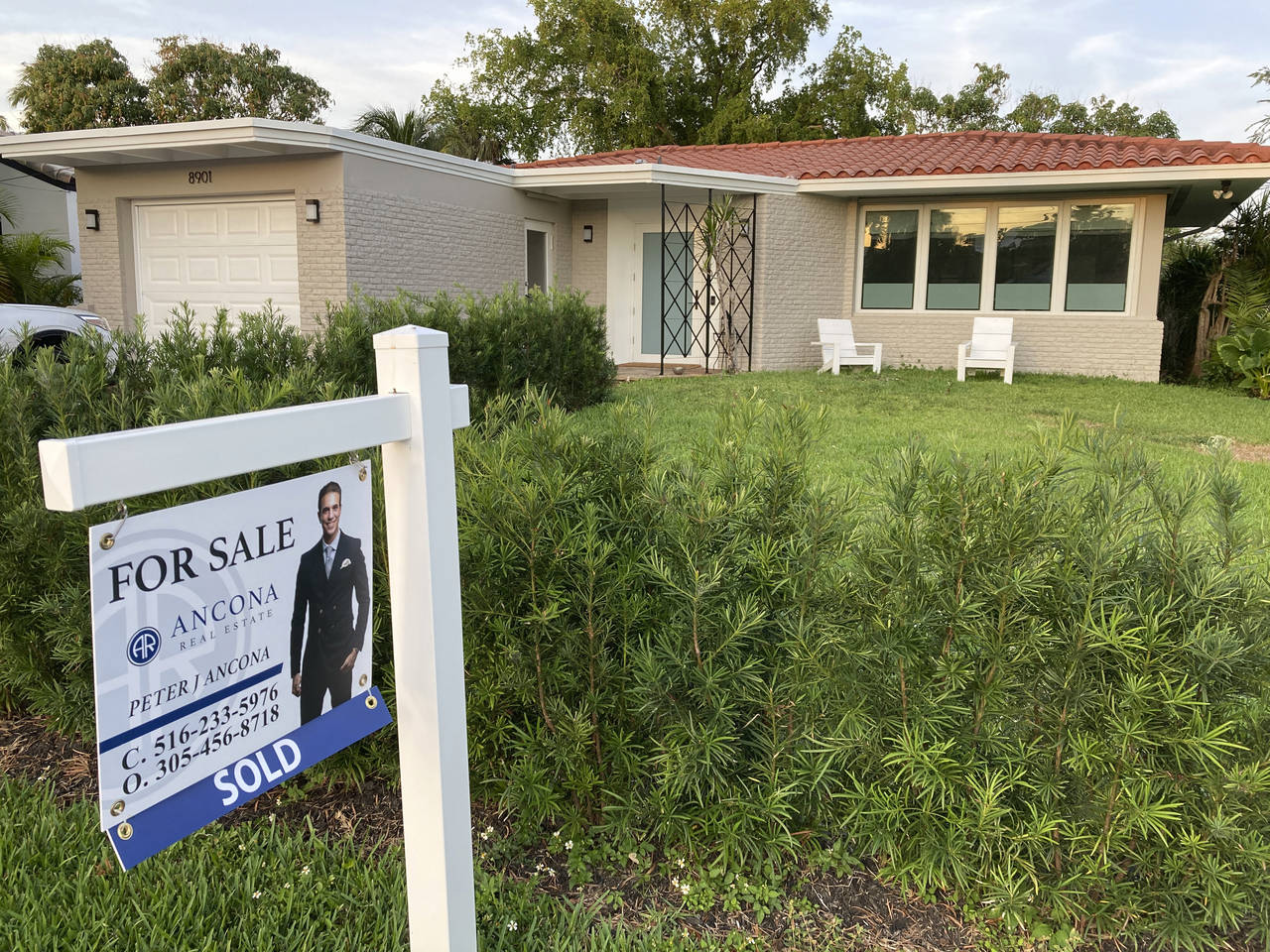 FILE - A home with a "Sold" sign is shown, Sunday, May 2, 2021, in Surfside, Fla.  Average long-ter...