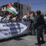 
              Palestinians protest against the visit of U.S. President Joe Biden to the West Bank town Bethlehem, in Dheisheh refugee camp, near Bethlehem, Friday, July 15, 2022. (AP Photo/Mahmoud Illean)
            