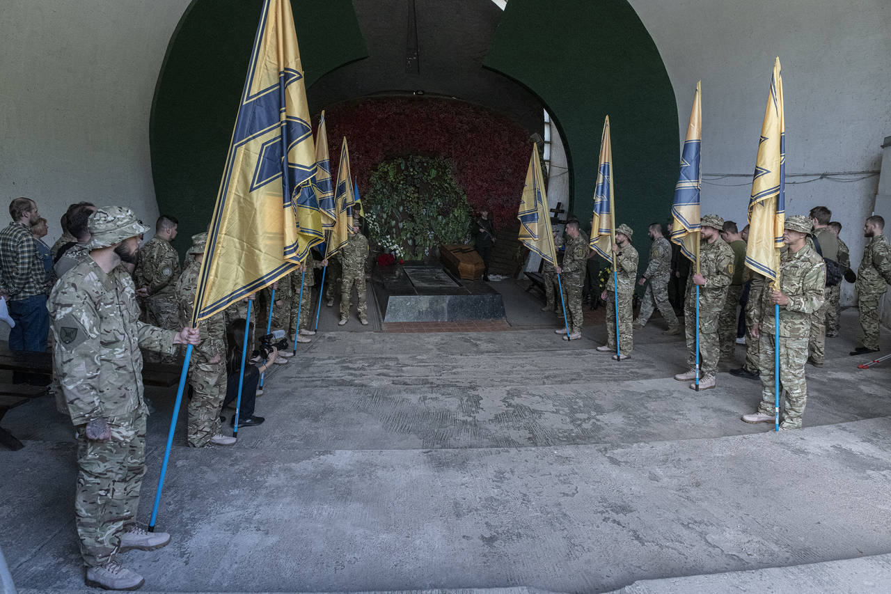 Soldiers of the Azov regiment pay their last tribute to a serviceman killed in a battle against Rus...