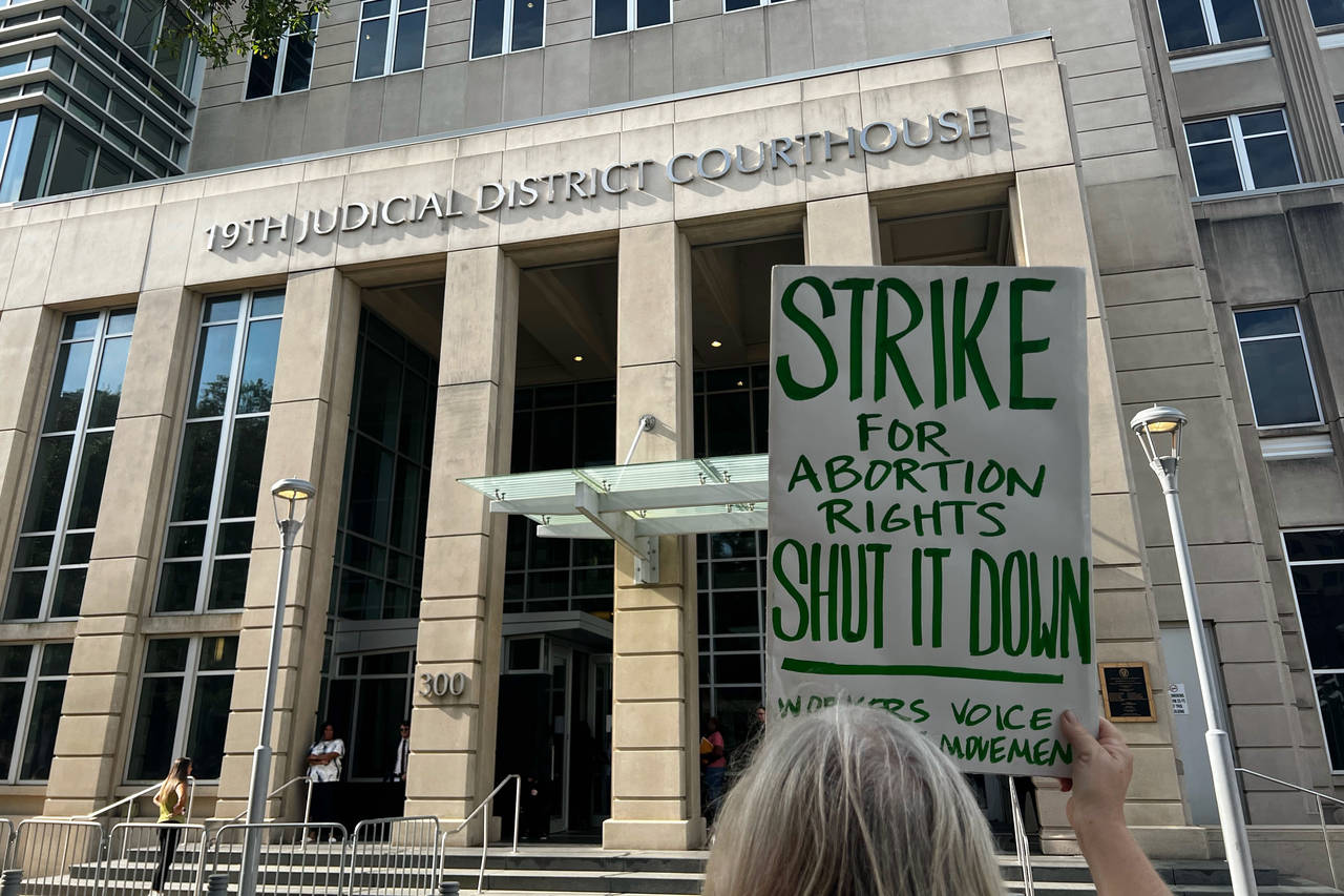 An abortion rights advocate demonstrates outside the 19th Judicial District Courthouse, Monday July...