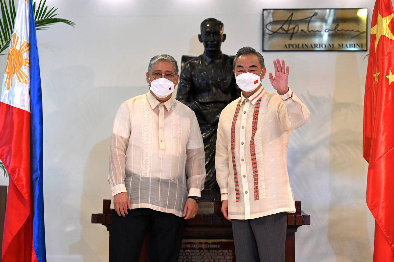 Philippine Foreign Affairs Secretary Enrique Manalo, left, and Chinese Foreign Minister Wang Yi pos...