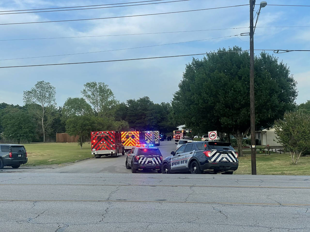 Law enforcement work the scene where multiple shots were fired near the area of Cedarcrest Drive an...