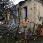 
              A local man clears rubble from his house which was destroyed after a Russian attack in a residential neighborhood in downtown Kharkiv, Ukraine, on Monday, July 11, 2022. The top official in the Kharkiv region said Monday the Russian forces launched three missile strikes on the city targeting a school, a residential building and warehouse facilities. (AP Photo/Evgeniy Maloletka)
            