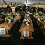 
              A  view of the coffins during a funeral service held in Scenery Park, East London, South Africa, Wednesday, July 6, 2022. More than a thousand grieving family and community members are attending the funeral in South Africa's East London for 21 teenagers who died in a mysterious tragedy at a nightclub nearly two weeks ago. South African President Cyril Ramaphosa is due to give the eulogy for the young who died. (AP Photo)
            