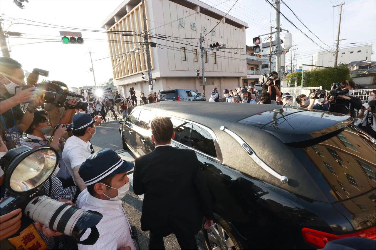 A hearse which is believed to carry the body of Japan's former Prime Minister Shinzo Abe leaves a h...