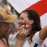 
              A supporter has the England flag painted on her face in the fan zone in Trafalgar Square as fans gather to watch on a big screen the final of the Women's Euro 2022 soccer match between England and Germany being played at Wembley stadium in London, Sunday, July 31, 2022. (AP Photo/Frank Augstein)
            