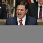 
              FILE - Arizona Republican Gov. Doug Ducey gives his state of the state address at the Arizona Capitol, Monday, Jan. 10, 2022, in Phoenix. Ducey has endorsed businesswoman Karrin Taylor Robson to be his successor. Ducey on Thursday added his name to a growing list of mainstream conservatives looking to boost the businesswoman past Donald Trump-endorsed frontrunner Kari Lake. (AP Photo/Ross D. Franklin, File)
            