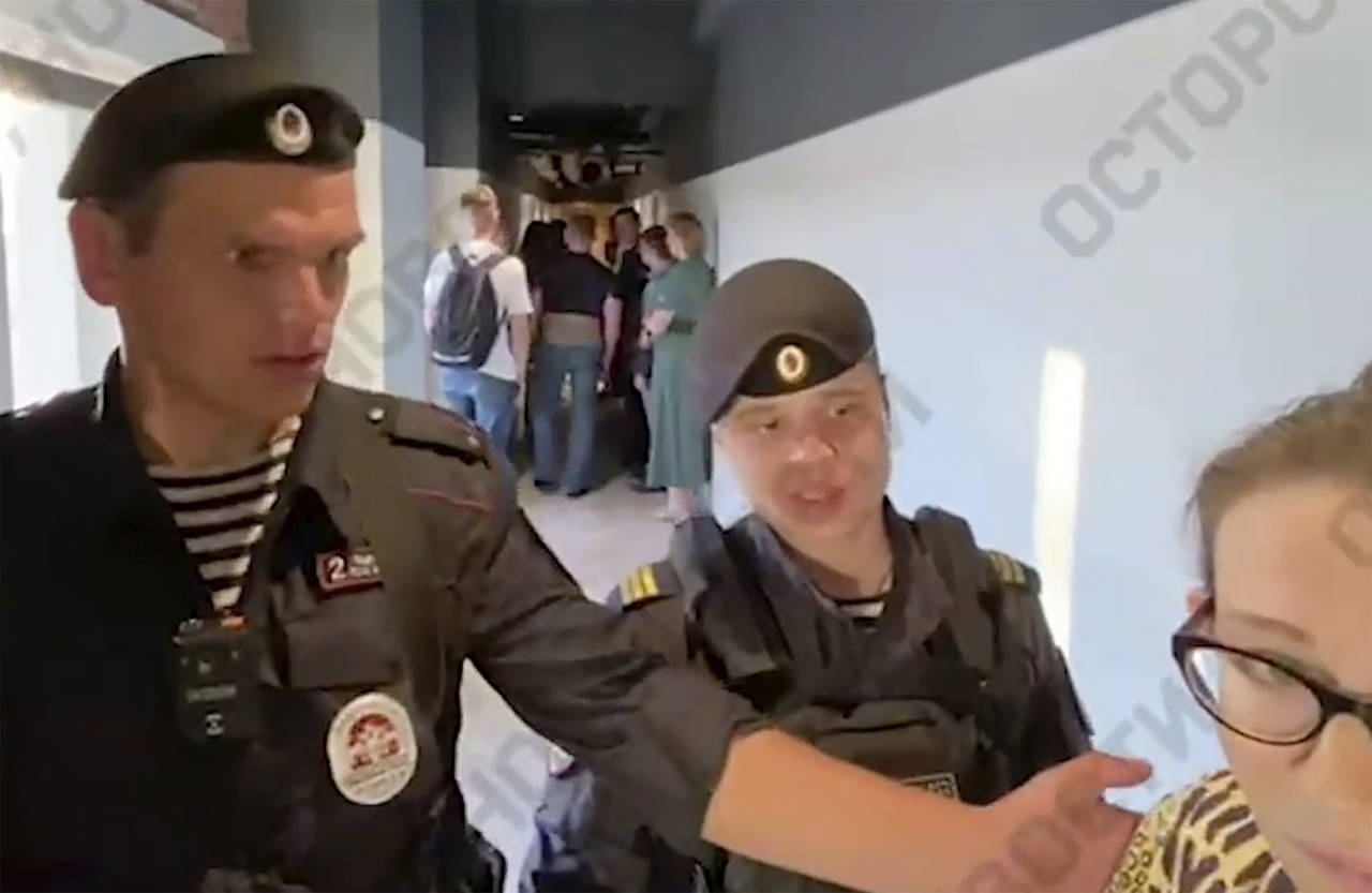This photo taken from video provided by Ostorozhno_novosti Telegram channel, Ilya Yashin, Police bl...