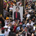 
              Myanmar nationals living in Thailand hold a picture of deposed Myanmar leader Aung San Suu Kyi as they protest outside Myanmar's embassy in Bangkok, Thailand, Tuesday, July 26, 2022. International outrage over Myanmar’s execution of four political prisoners is intensifying with grassroots protests and strong condemnation from world governments. (AP Photo/Sakchai Lalit)
            