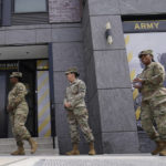 
              FILE - The U.S. Army National Guard members stand outside the Army National Guard office during training April 21, 2022 in Washington.  In March the local guard opened its first proper recruiting office in the city since 2010. The Army is significantly cutting the total number of soldiers it expects to have in the force over the next two years, as the U.S. military faces what a top general called “unprecedented challenges” in bringing in new recruits. (AP Photo/Mariam Zuhaib)
            