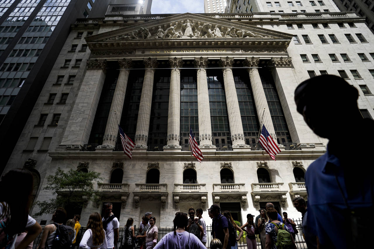 FILE - Pedestrians walk past the New York Stock Exchange on  Friday, July 8, 2022, in New York. Sto...