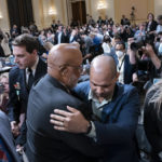 
              Chairman Bennie Thompson, D-Miss., center left, embraces U.S. Capitol Police Sgt. Aquilino Gonell, as the House select committee investigating the Jan. 6 attack on the U.S. Capitol finished a hearing on extremist groups, at the Capitol in Washington, Tuesday, July 12, 2022. At left is Stephen Ayres, who pleaded guilty in June 2022 to disorderly and disruptive conduct in a restricted building, and who was a witness at the hearing. (AP Photo/J. Scott Applewhite)
            