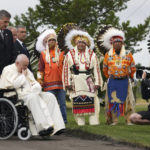 
              Pope Francis prays in front of Indigenous chiefs at the Ermineskin Cree Nation Cemetery in Maskwacis, Albera, during his papal visit across Canada on Monday, July 25, 2022. (Nathan Denette/The Canadian Press via AP)
            