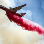 
              An air tanker drops retardant while battling the Electra Fire in the Pine Acres community of Amador County, Calif., on Tuesday, July 5, 2022. (AP Photo/Noah Berger)
            