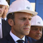 
              French President Emmanuel Macron listens to explanations as he visits the STMicroelectronics (STM) company in Crolles, southeastern France, Tuesday July 12, 2022. Emmanuel Macron announced on July 11, 2022 5.7 billion euros investment by Franco-Italian STMicroelectronics and American GlobalFoundries to build a semiconductor plant in Crolles, near Grenoble. (Jean-Philippe Ksiazek, pool via AP)
            