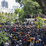 
              Sri Lankan protesters storm prime minister Ranil Wickremesinghe 's office, demanding he resign after president Gotabaya Rajapaksa fled amid economic crisis in Colombo, Sri Lanka, Wednesday, July 13, 2022. (AP Photo/Rafiq Maqbool)
            