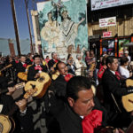 
              FILE - Mariachis participate in the annual Mariachi procession and Mass in the Boyle Heights selection of Los Angeles, Tuesday, Nov. 24, 2009. With the blasting of trumpets and the strumming of guitars, the U.S. Postal Service is celebrating the release of a new series of stamps honoring the traditional Mexican genre of mariachi. The first-day-of-issue ceremony was held Friday, July 15, 2022, in New Mexico's largest city during the 30th annual Mariachi Spectacular de Albuquerque. (AP Photo/Richard Vogel, File)
            
