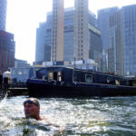 
              A swimmer in water in the Canary Wharf docklands in east London, Tuesday July 19, 2022. Britain shattered its record for highest temperature ever registered amid a heat wave that has seized swaths of Europe. The national weather forecaster predicted it would get hotter still Tuesday in a country ill prepared for such extremes. (Victoria Jones/PA via AP)
            