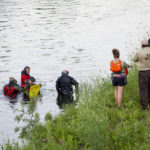 
              Water Recovery authorities comb the Apple River with metal detectors after five people were stabbed while tubing down the river, Saturday, July 30, 2022, in Somerset, Wis. (Alex Kormann/Star Tribune via AP)
            