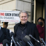 
              Former White House strategist Steve Bannon, center, walks to speak with reporters as he departs federal court on Friday, July 22, 2022, in Washington. Accompanying Bannon are his attorneys David Schoen, left, and M. Evan Corcoran.  Bannon, a longtime ally of former President Donald Trump has been convicted of contempt charges for defying a congressional subpoena from the House committee investigating the Jan. 6 insurrection at the U.S. Capitol. (AP Photo/Alex Brandon)
            