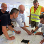 
              Firefighters and civil protection personnel work at a field command post in the village of Villandraut, near Landiras, southwestern France, Monday, July 18, 2022. France scrambled more water-bombing planes and hundreds more firefighters to combat spreading wildfires that were being fed Monday by hot swirling winds from a searing heat wave broiling much of Europe. With winds changing direction, authorities in southwestern France announced plans to evacuate more towns and move out 3,500 people at risk of finding themselves in the path of the raging flames. (AP Photo/Bob Edme)
            