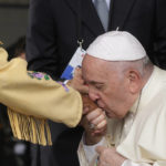 
              Pope Francis kisses hand to Canadian Indigenous woman as he arrives at Edmonton's International airport, Canada, Sunday, July 24, 2022. Pope Francis crisscrossed Canada this week delivering long overdue apologies to the country's Indigenous groups for the decades of abuses and cultural destruction they suffered at Catholic Church-run residential schools. (AP Photo/Gregorio Borgia)
            