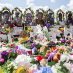 
              A memorial for the supermarket shooting victims is set up outside the Tops Friendly Market on Thursday, July 14, 2022, in Buffalo, N.Y. N.Y. The Buffalo supermarket where 10 Black people were killed by a white gunman is set to reopen its doors, two months after the racist attack. (AP Photo/Joshua Bessex)
            