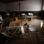 
              Chairs and pews sink down in mud inside Baptist Bible Church, Thursday, July 14, 2022 in Whitewood, Va., following a flash flood. Virginia Gov. Glenn Youngkin declared a state of emergency to aid in the rescue and recovery efforts from Tuesday's floodwaters. (AP Photo/Michael Clubb)
            