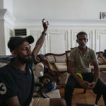 
              Protesters shout slogans as they stay and play cards in prime minister's official residence a day after it was stormed in Colombo, Sri Lanka, Sunday, July 10, 2022. Sri Lanka’s president and prime minister agreed to resign Saturday after the country’s most chaotic day in months of political turmoil, with protesters storming both officials’ homes and setting fire to one of the buildings in a rage over the nation's severe economic crisis.(AP Photo/Eranga Jayawardena)
            