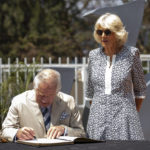 
              Britain's Prince Charles, accompanied by Camilla, Duchess of Cornwall, signs the visitors book at the Kigali Genocide Memorial in the capital Kigali, Rwanda Wednesday, June 22, 2022. Prince Charles has become the first British royal to visit Rwanda, representing Queen Elizabeth II as the ceremonial head of the Commonwealth at a summit where both the 54-nation bloc and the monarchy face uncertainty. (AP Photo)
            