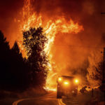 
              Flames rise above Darrah Rd. as the Oak Fire burns in Mariposa County, Calif., on Friday, July 22, 2022. (AP Photo/Noah Berger)
            