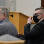 
              Volodymyr Zhukovskyy, of West Springfield, Mass., right, charged with negligent homicide in the deaths of seven motorcycle club members in a 2019 crash, is seated during his trial with defense attorney Steve Mirkin, left, at attorney Coos County Superior Court in Lancaster, N.H., Tuesday, July 26, 2022. Zhukovskyy has pleaded not guilty to multiple counts of negligent homicide, manslaughter, reckless conduct and driving under the influence in the June 21, 2019, crash. (AP Photo/Steven Senne, Pool)
            