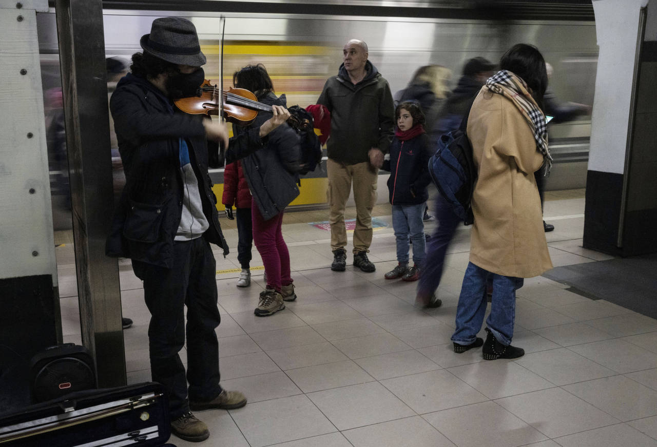 Roman, 28, from Colombia, plays the violin inside the subway in Buenos Aires, Argentina, Monday, Ju...