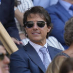 
              Film star Tom Cruise smiles sits in the Royal Box for the final of the women's singles between Tunisia's Ons Jabeur and Kazakhstan's Elena Rybakina on day thirteen of the Wimbledon tennis championships in London, Saturday, July 9, 2022. (AP Photo/Kirsty Wigglesworth)
            