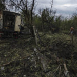 
              A man walks away from a crater in the aftermath of a Russian rocket attack, that killed 35-year-old Anna Protsenko, on the outskirts of Pokrovsk, eastern Ukraine, Saturday, July 16, 2022. Protsenko was killed two days after coming home. She had done what authorities wanted, evacuating eastern Ukraine's Donetsk region as Russian forces move closer, but starting a new life elsewhere was uncomfortable and expensive. (AP Photo/Nariman El-Mofty)
            