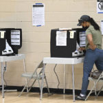 
              Faustina Hernandez of Columbia, votes in-person using a voting machine at Long Reach High School, Tuesday, July 19, 2022, in Columbia, Md. (Jeffrey F. Bill/The Baltimore Sun via AP)
            