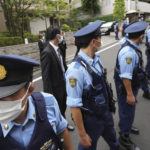 
              Police officers stand guard in front of the residence of Japan's former Prime Minister Shinzo Abe Saturday, July 9, 2022, in Tokyo. The body of Japan’s former Prime Minister Shinzo Abe was returned to Tokyo on Saturday after he was fatally shot during a campaign speech in western Japan a day earlier.(AP Photo/Eugene Hoshiko)
            