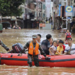 
              FILE - In this file photo released by Xinhua News Agency, rescuers evacuate stranded residents in flood water in Tuojiang Township, Jianghua Yao Autonomous County, Yongzhou in central China's Hunan Province, June 22, 2022. From the snowcapped peaks of Tibet to the tropical island of Hainan, China is sweltering under the worst heatwave in decades while rainfall hit records in June. (Jiang Linfeng/Xinhua via AP, File)
            