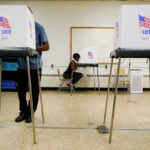 
              People cast votes at Edmondson Westside High School during Maryland's primary election, Tuesday, July 19, 2022, in Baltimore. (AP Photo/Julio Cortez)
            