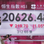 
              A man wearing a face mask walks past a bank's electronic board showing the Hong Kong share index in Hong Kong, Tuesday, July 19, 2022. Asian shares were mixed Tuesday, as investors weighed oil prices, inflation worries and corporate earnings. Benchmarks in Tokyo and Shanghai were higher in morning trading. Shares fell in Sydney, South Korea and Hong Kong, where investor sentiments were subdued after an early rally evaporated on Wall Street. (AP Photo/Kin Cheung)
            