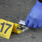 
              A bullet is marked by a police investigator at the scene, in front of the Ateneo de Manila University in Quezon city, Philippines, Sunday, July 24, 2022. At least three people, including a former Philippine town mayor, were killed and another was wounded in a brazen attack on Sunday by a gunman in a university campus in the capital region, officials said. (AP Photo/Aaron Favila)
            