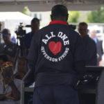 
              Tops Friendly Markets employee Pat Patterson reads a poem during a ceremony to honor the victims on the two-month anniversary of the attack by a racist gunman at a memorial outside the store in Buffalo, N.Y., which is slated to reopen tomorrow, Thursday, July 14, 2022. (Derek Gee/The Buffalo News via AP)
            