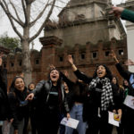 
              Women sing Peronist songs outside the cemetery where they visited the tomb of Argentina's late first lady Maria Eva Duarte de Peron, better known as Evita in Buenos Aires, Argentina, Tuesday, July 26, 2022. Argentines commemorate the 70th anniversary of the death of their most famous first lady, who died of cancer on July 26, 1952 at the age of 33. (AP Photo/Natacha Pisarenko)
            