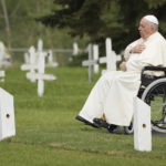 
              Pope Francis prays at a gravesite at the Ermineskin Cree Nation Cemetery in Maskwacis, Alberta, during his papal visit across Canada on Monday, July 25, 2022. (Nathan Denette/The Canadian Press via AP)
            
